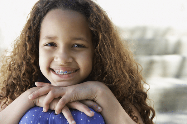 smiling child with braces